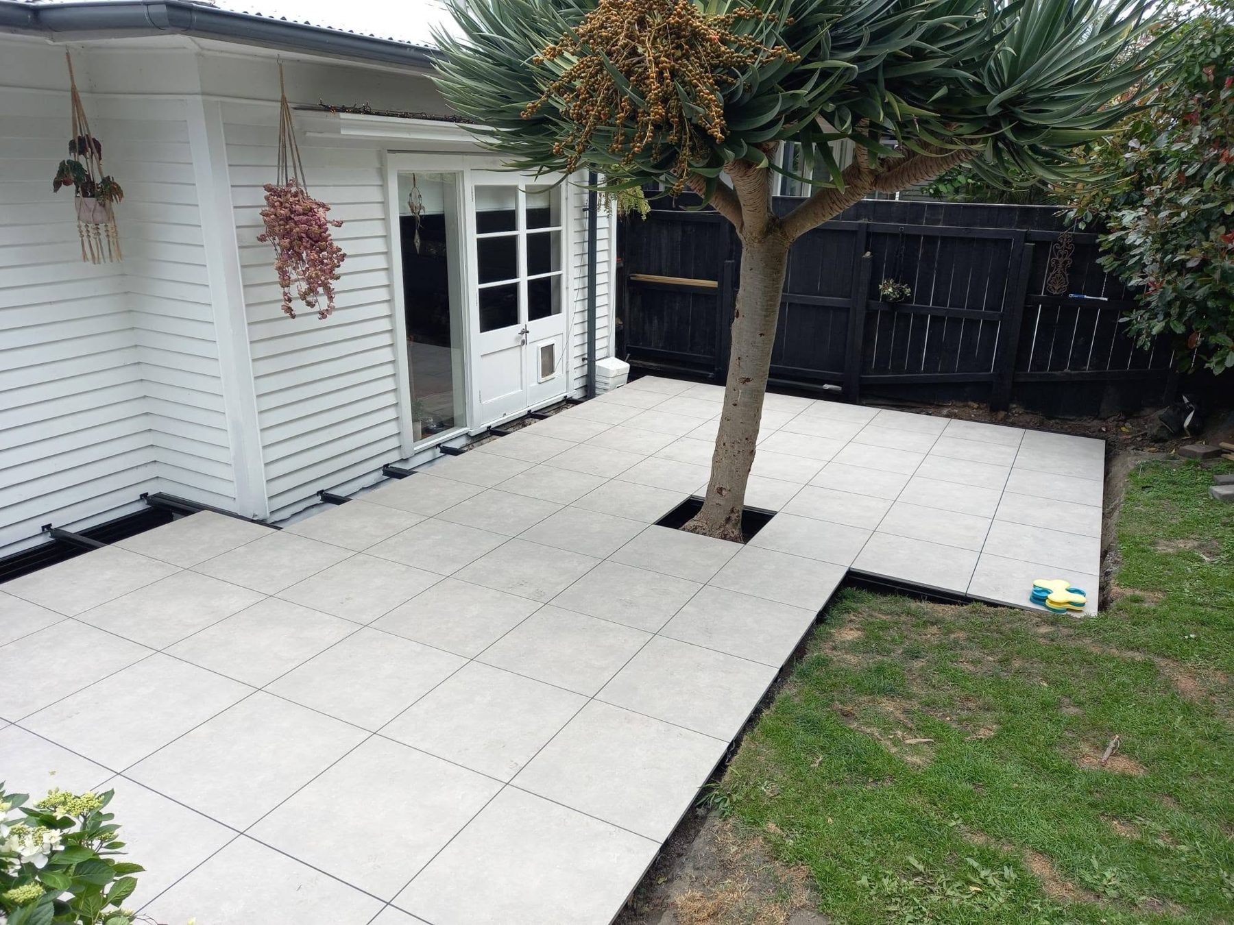 Finished tiled outdoor patio beside the house