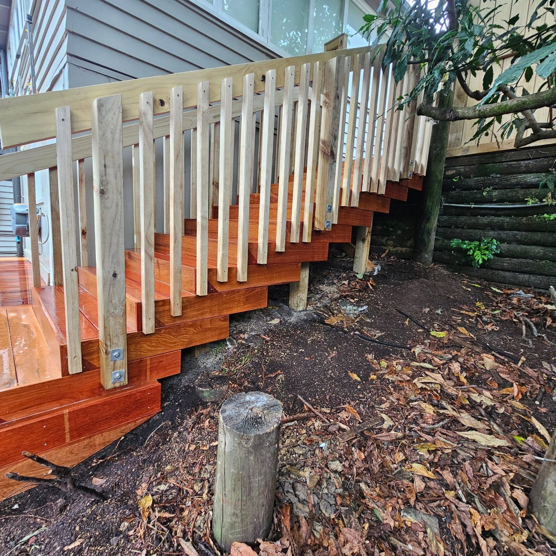 Hardwood stairs and handrail finished against the garden edge