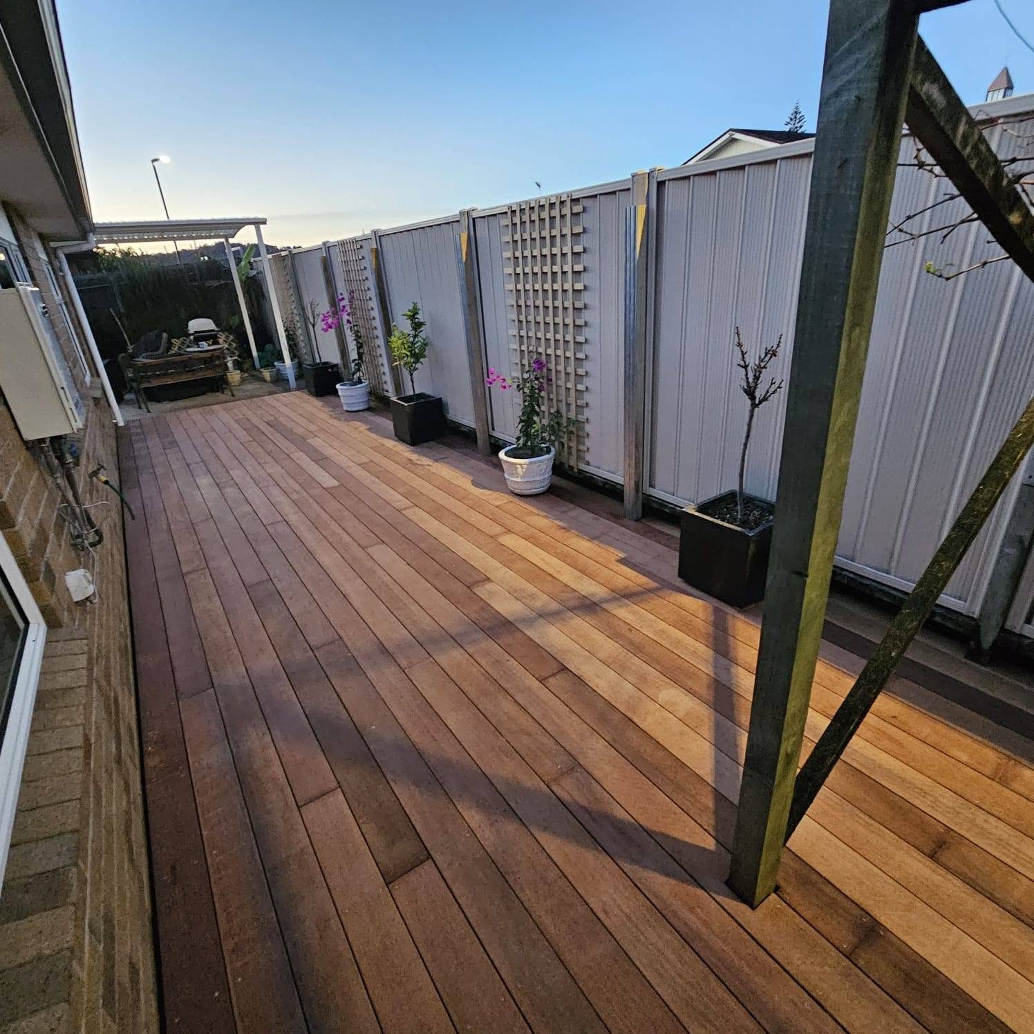 Finished hardwood courtyard deck with planters and privacy screening