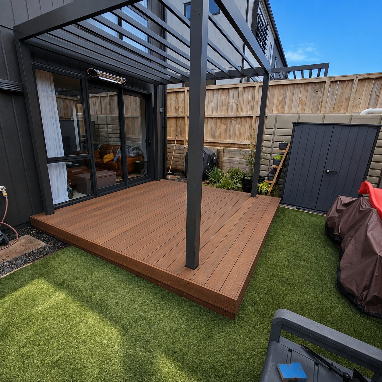 Completed kwila deck built under a louvre roof after a full deck replacement