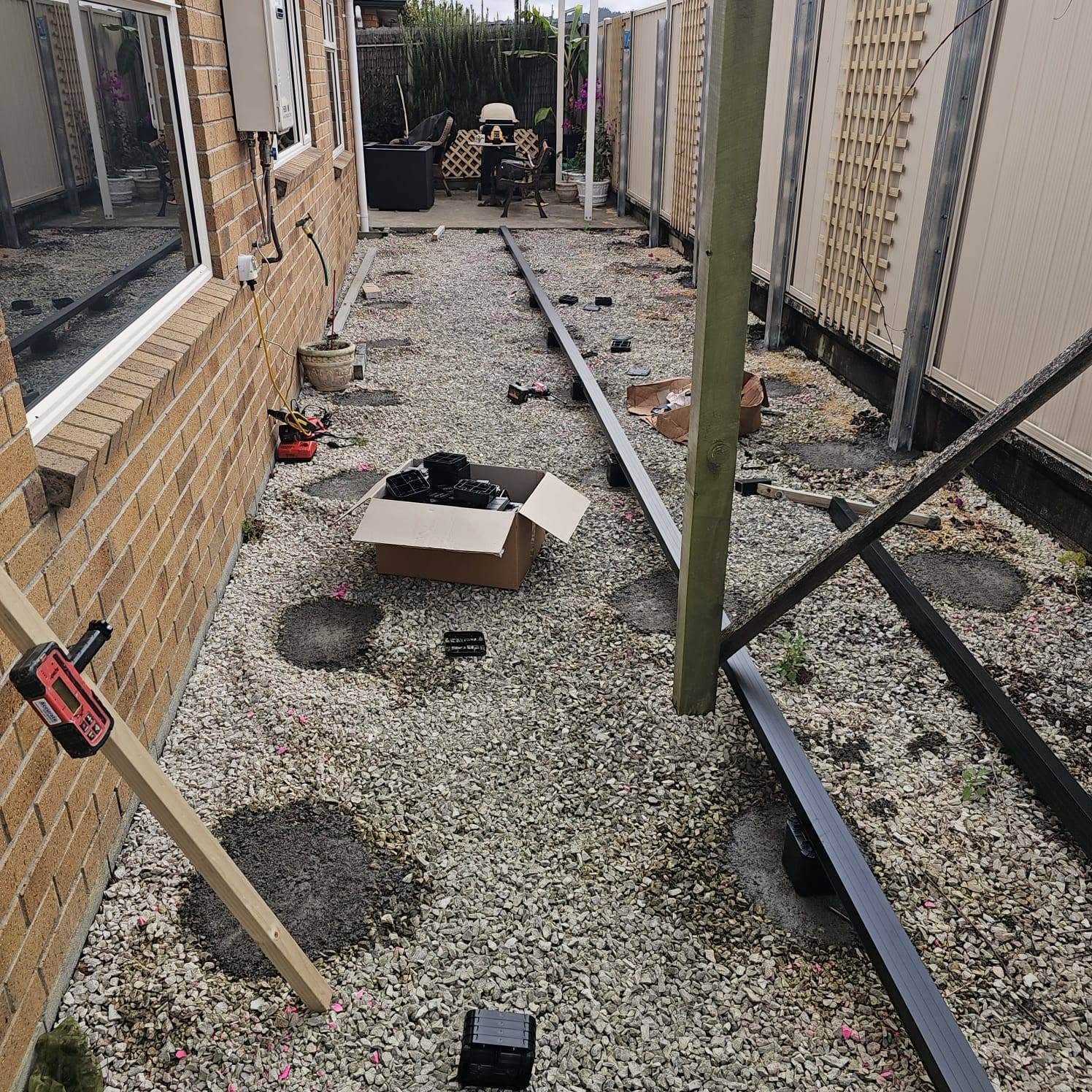 Narrow gravel side courtyard before any decking was built