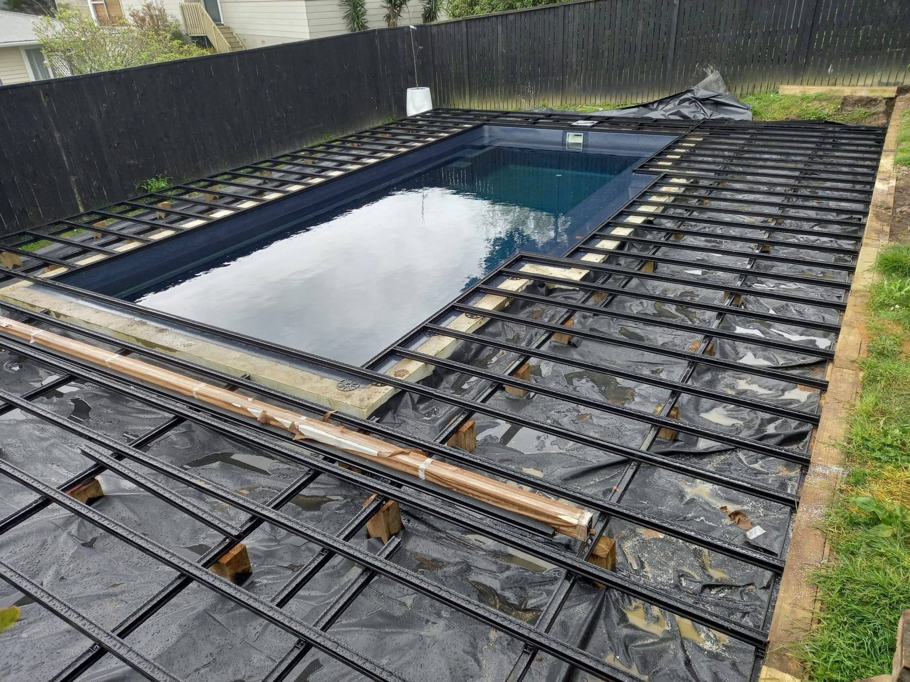 Deck substructure framed around the pool before boards go down
