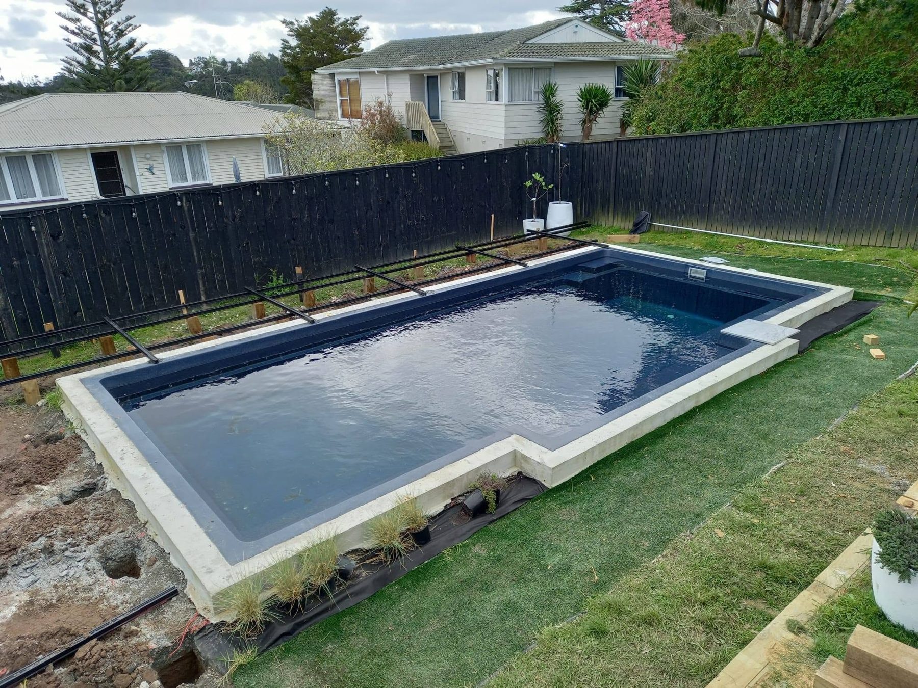 Newly installed pool shell in a bare yard before the surround was built