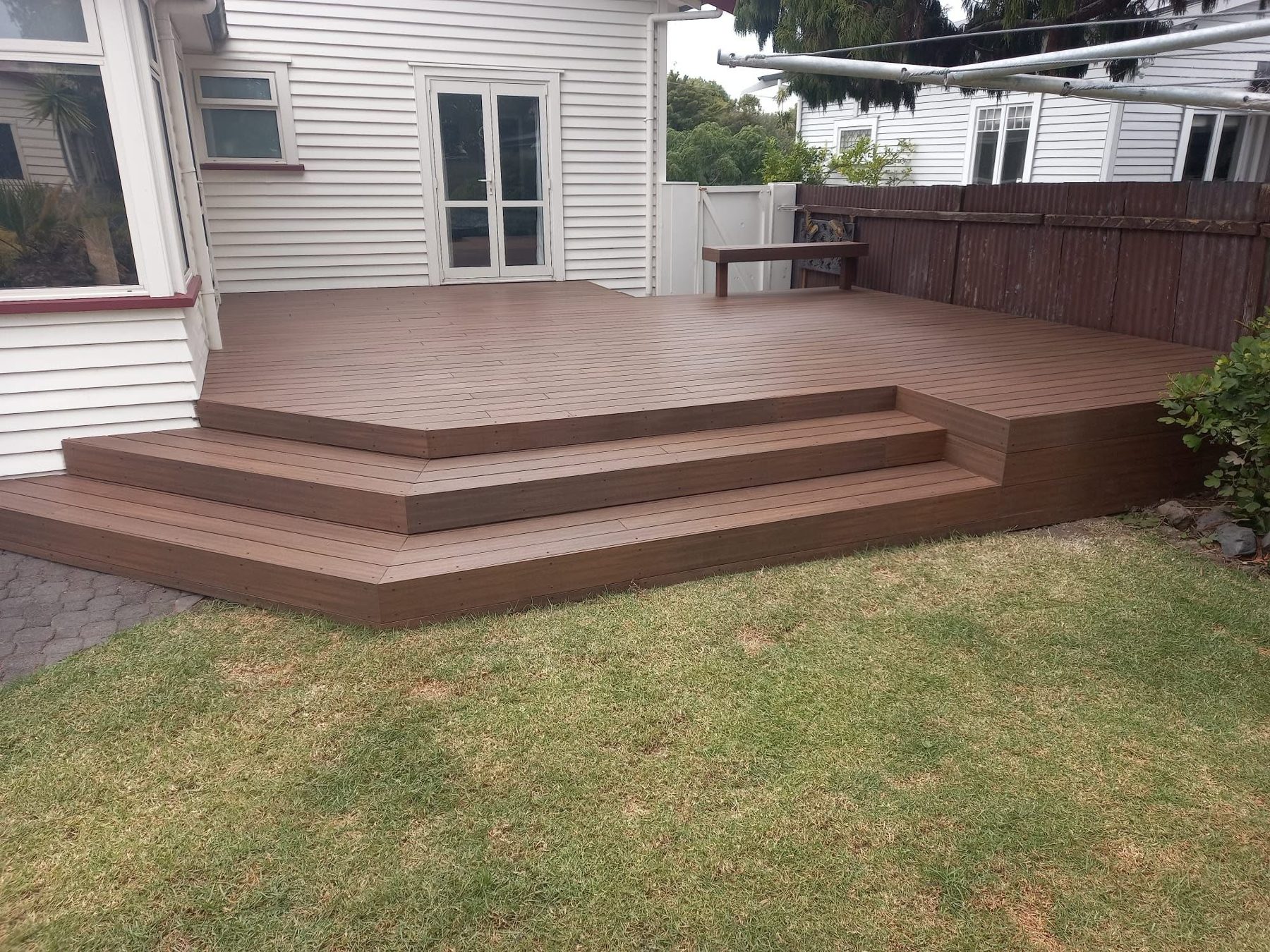 Wide composite steps cascading down to the lawn